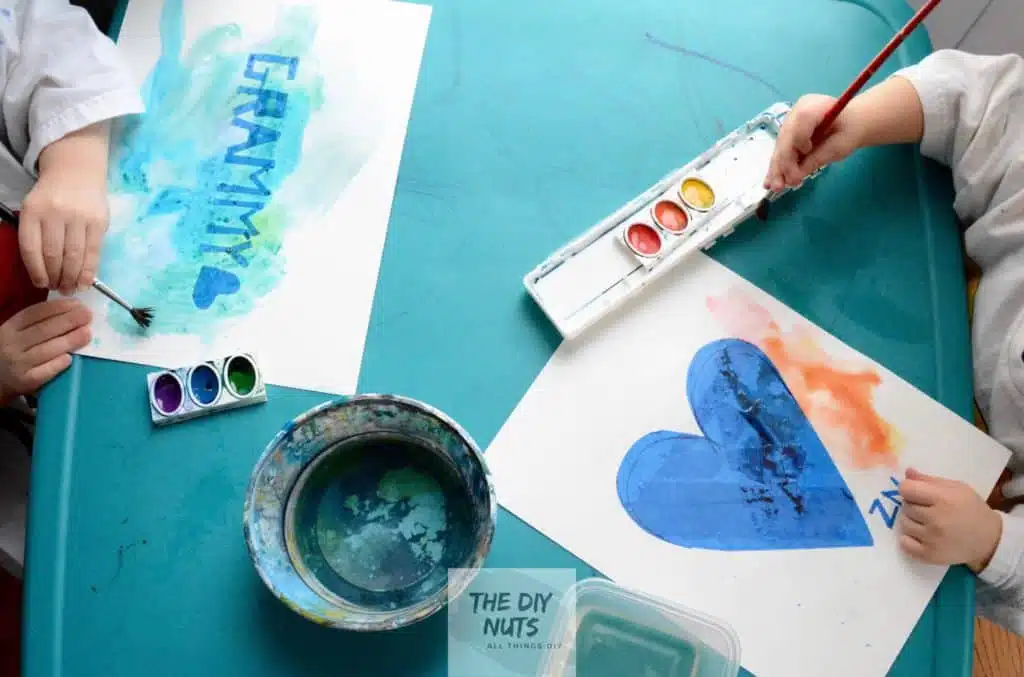 preschooler hands painting grammy and heart easy watercolor paint project