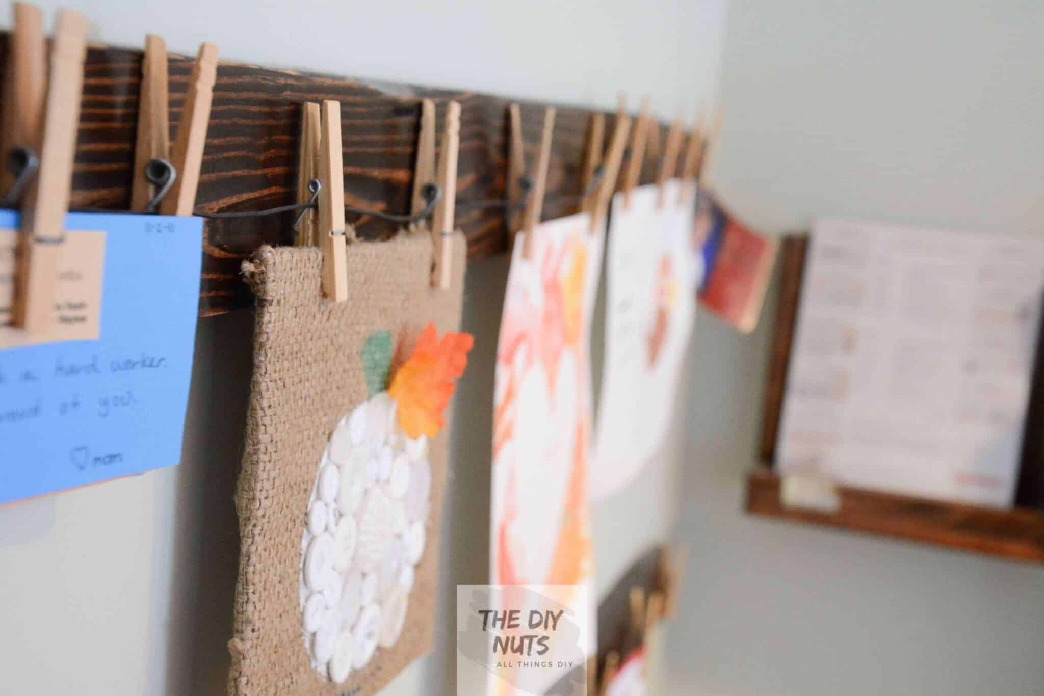 Stained Pallet Wood with Clothespin displaying toddler and kid art projects