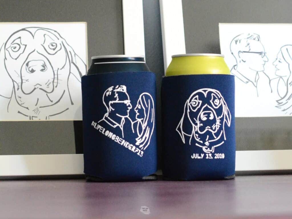 two blue can Koozie with white line drawings and framed artwork.