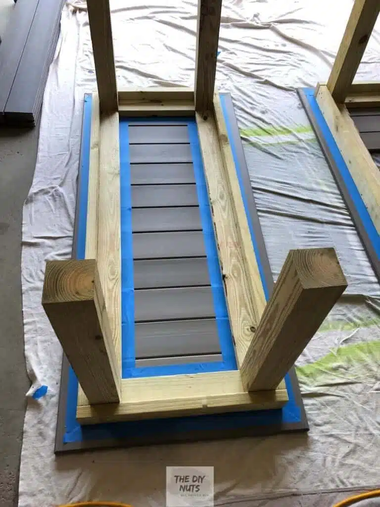 Blue painter's tape used to separate pressure treated wood outdoor table base and composite decking table top