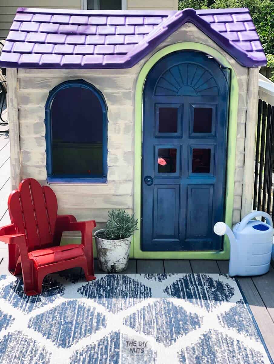 Blue, cream and purple little tykes playhouse with small red chair and marbled pot with plant