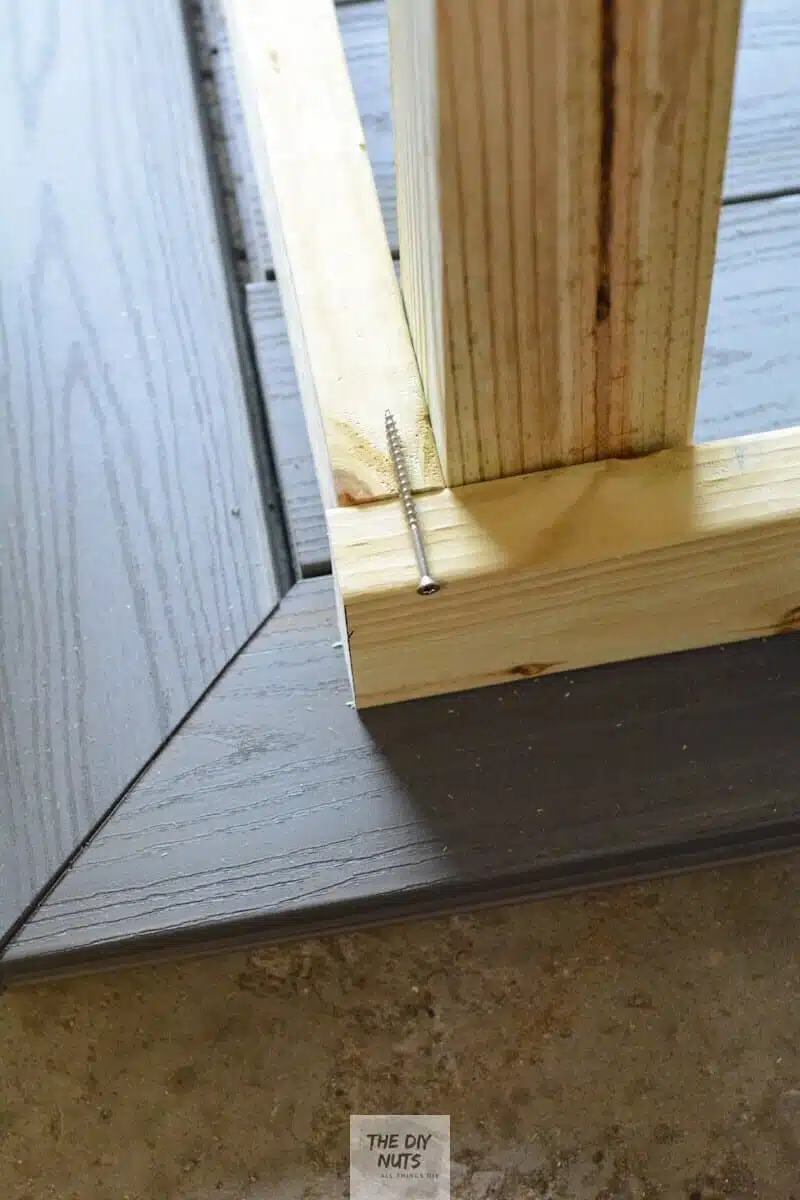 Long galvanize screw used to attach pressure treated wood post to outdoor wood table