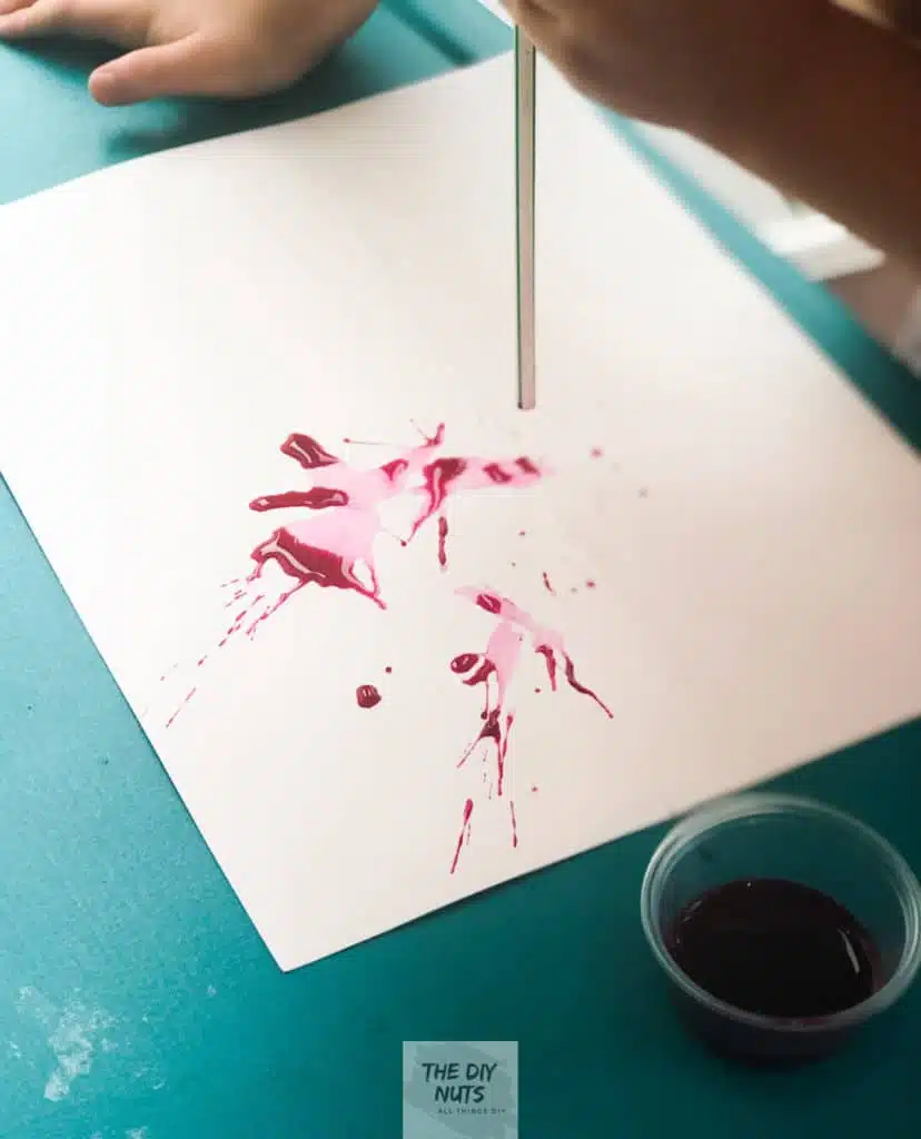 4 year-old Blowing Watercolor Paint to create an abstract painting