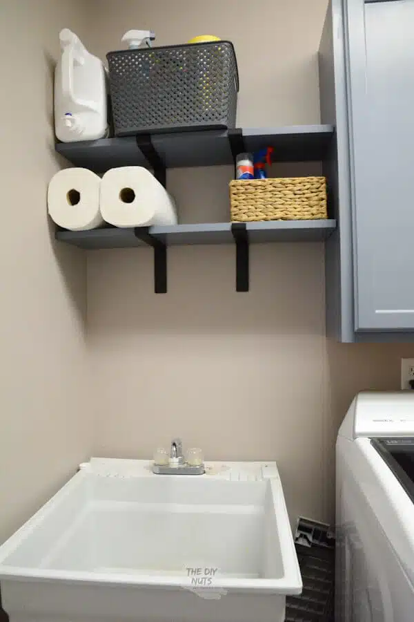 DIY laundry room shelves over utility sink