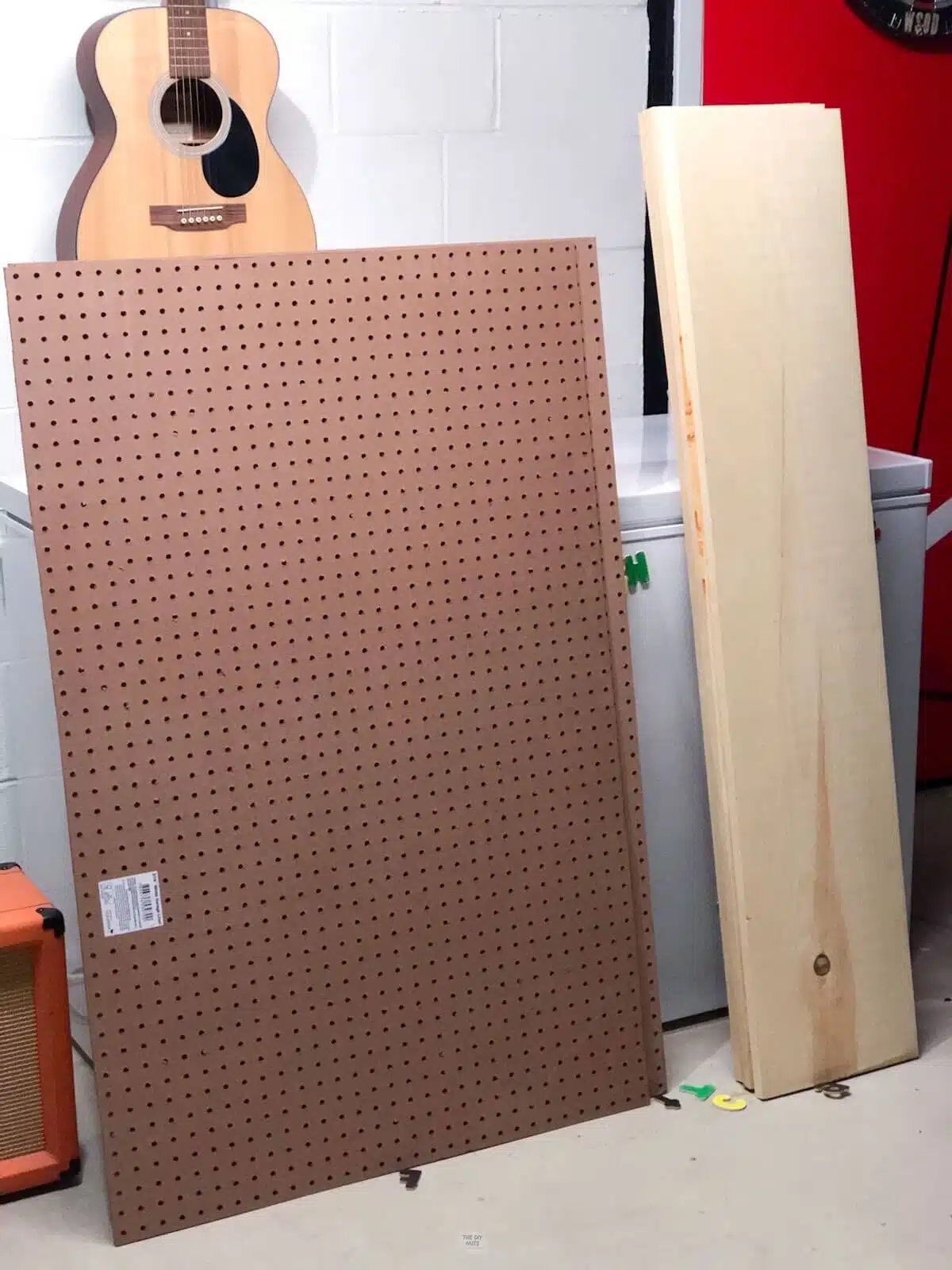 pegboard and wood leaning against deep freezer.
