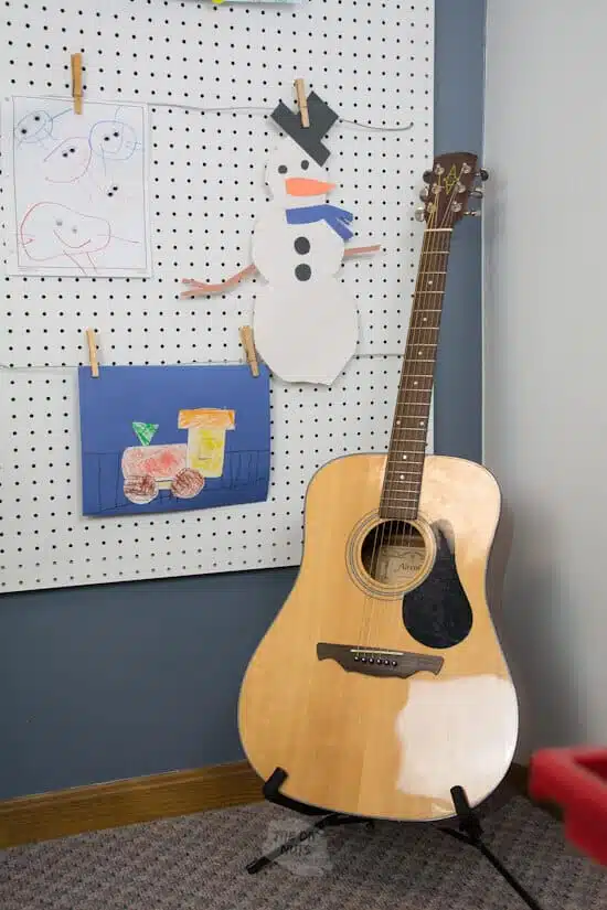 DIY pegboard art display with guitar