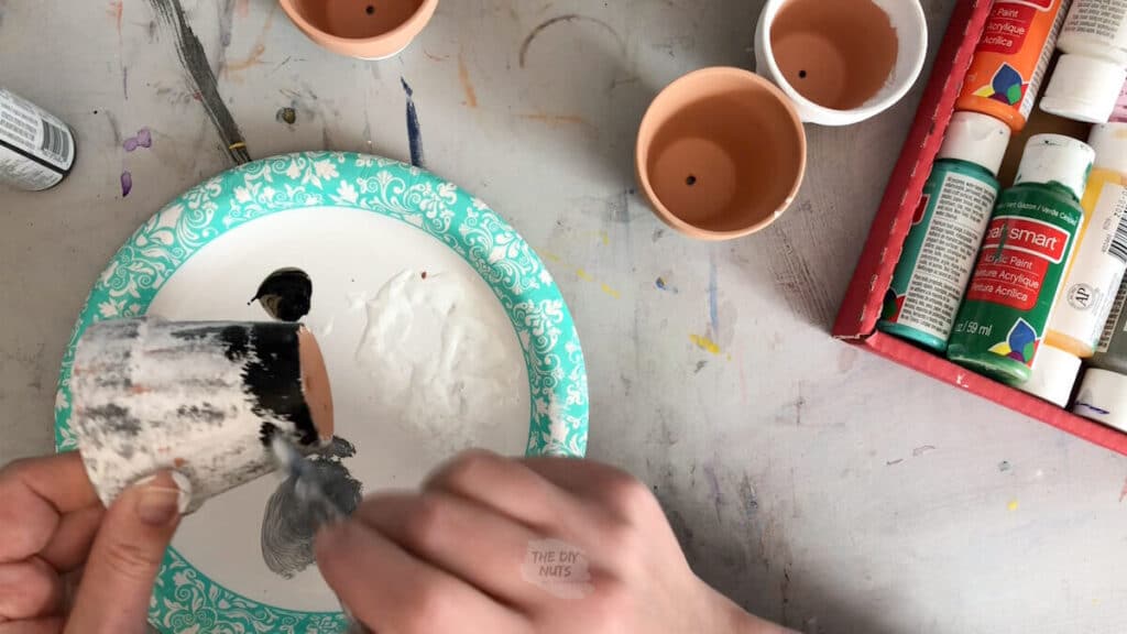 dabbing paint to create an easy painted terracotta pot