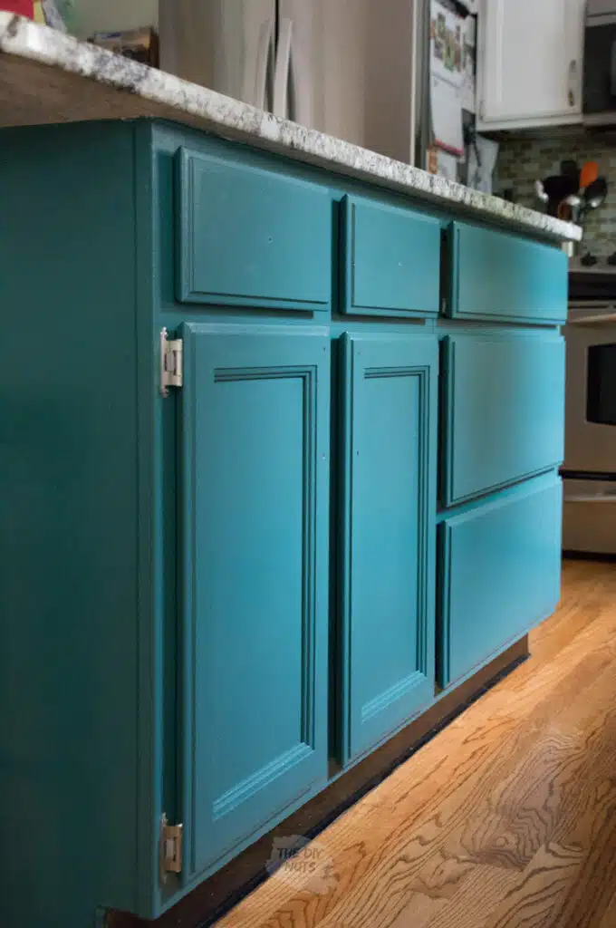 green painted kitchen cabinet in island.