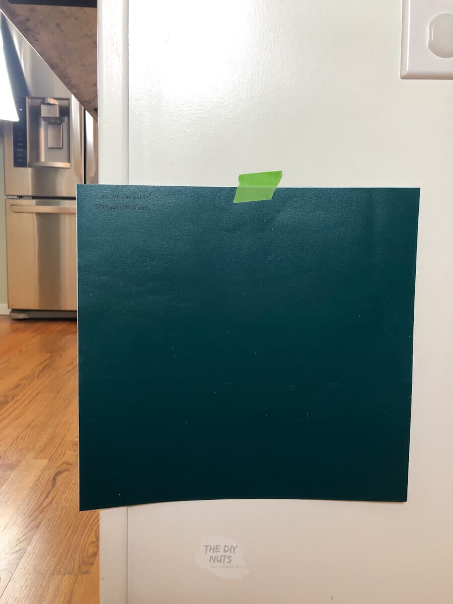 Teal Samplize paint sample with painter's tape on cabinet