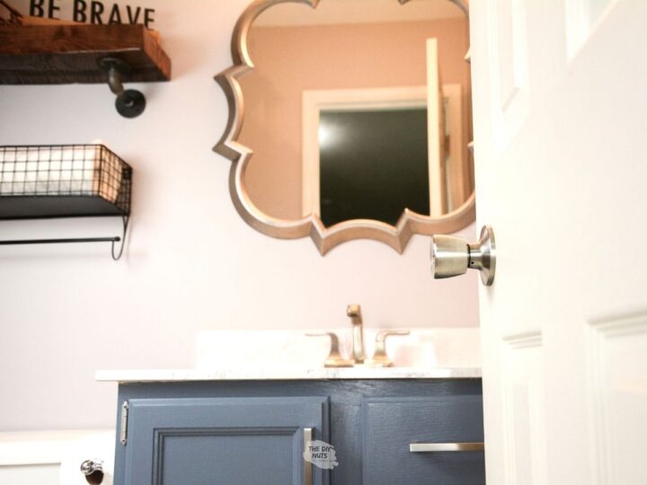 Behr charcoal blue painted bathroom vanity cabinets with sliver mirro