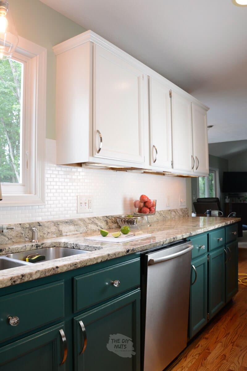 white upper cabinets with green lower and white painted backsplash