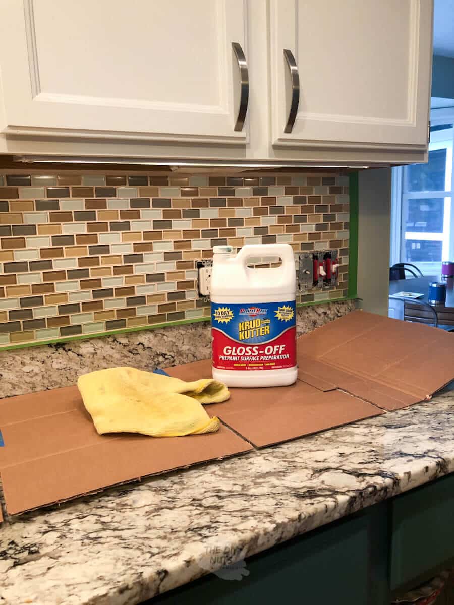 krud kutter and frog tape on counter in front of to-be painted backsplash