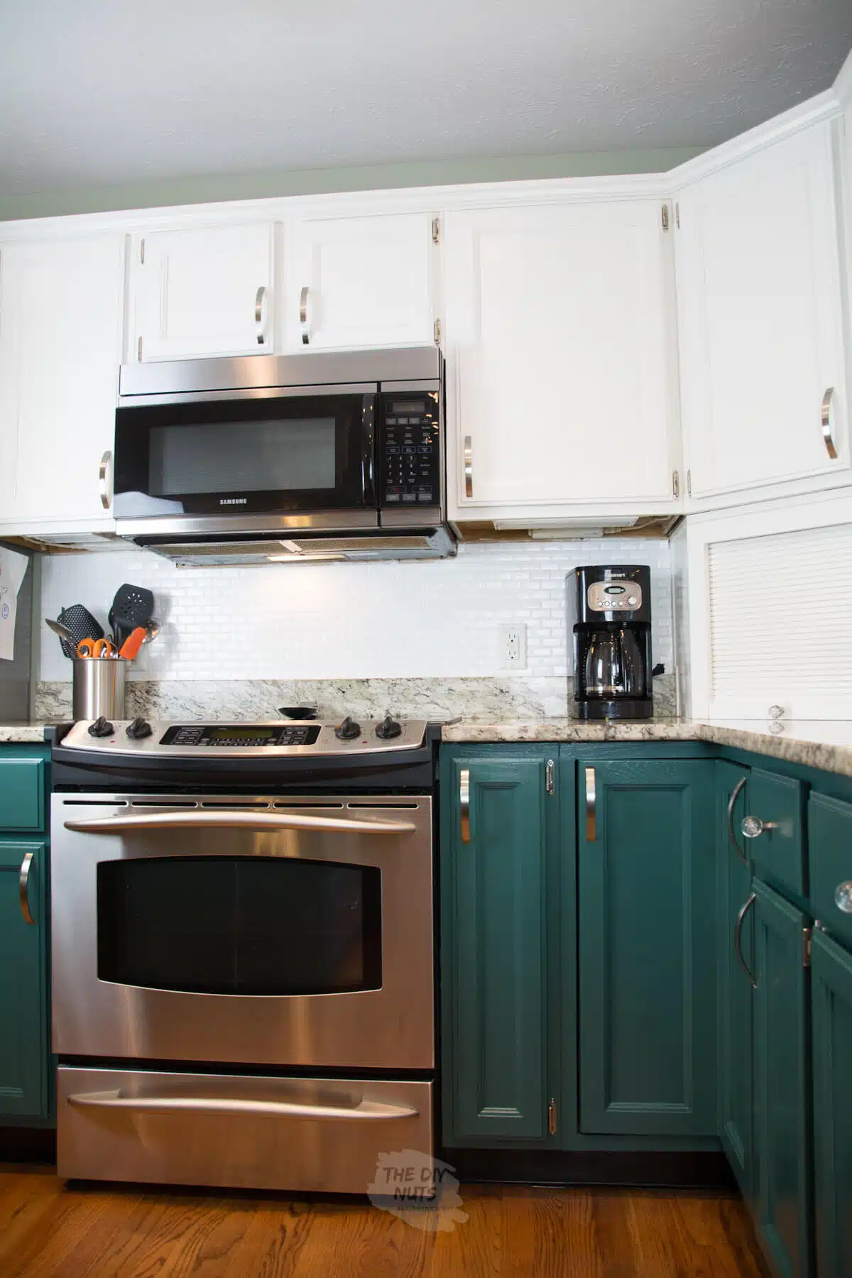 SW rookwood sash green painted lower cabinets and white upper cabinets in kitchen makeover.
