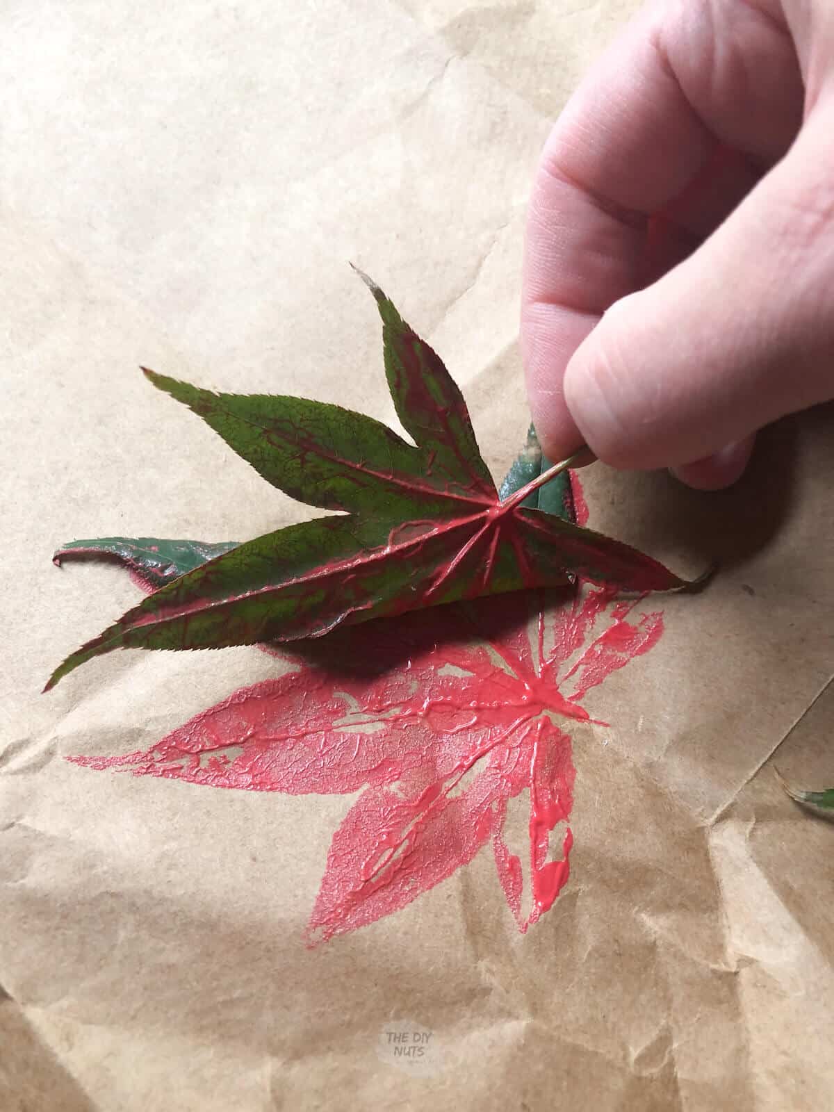leaf being pulled up after printing on brown paper bag