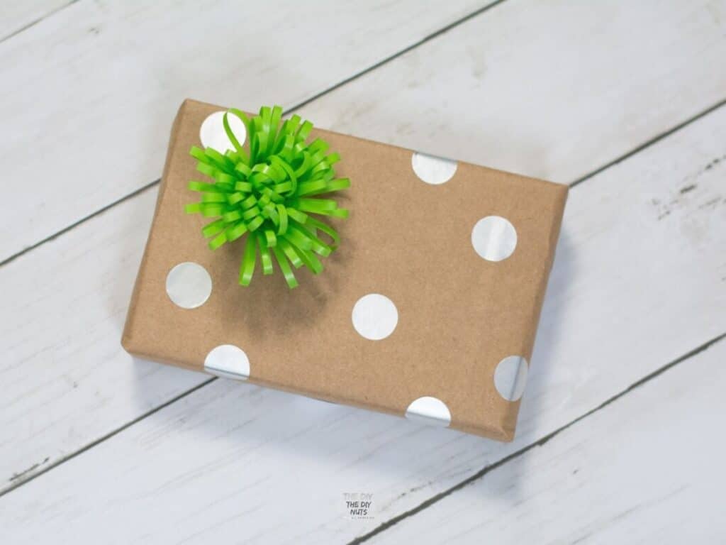 polka dot homemade wrapping paper out of brown bag with green bow