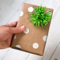 handing holding homemade polka wrapping paper wrapped present