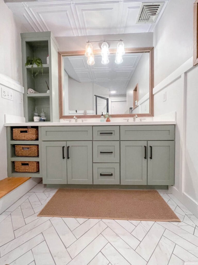 SW evergreen fog painted bathroom vanity with wood framed mirror and pendant lights
