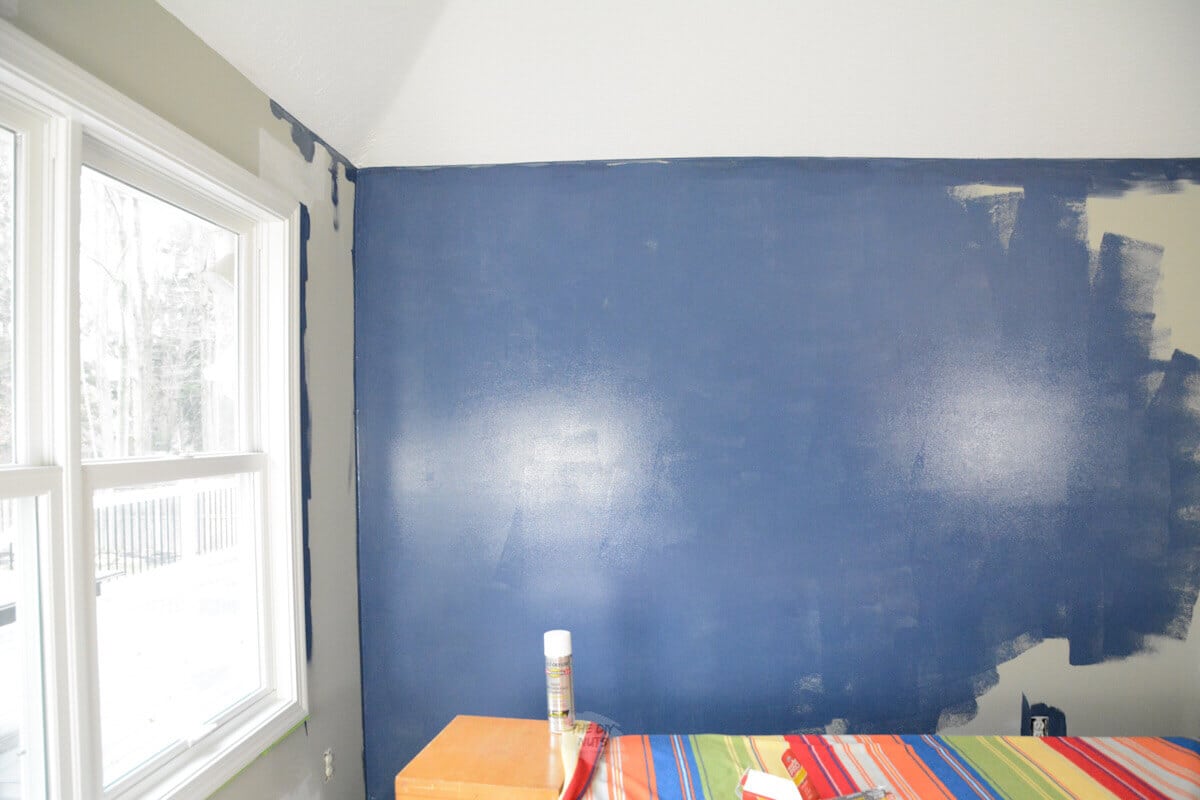 Navy blue walls being painted for the first coat