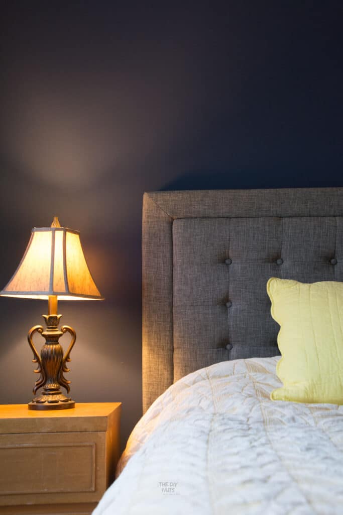 gray and navy bedroom idea with lamp, gray headboard and West Elm geometric bedding