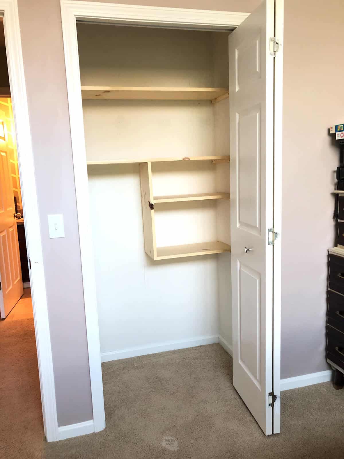 finished whitewood closet shelves in small closet
