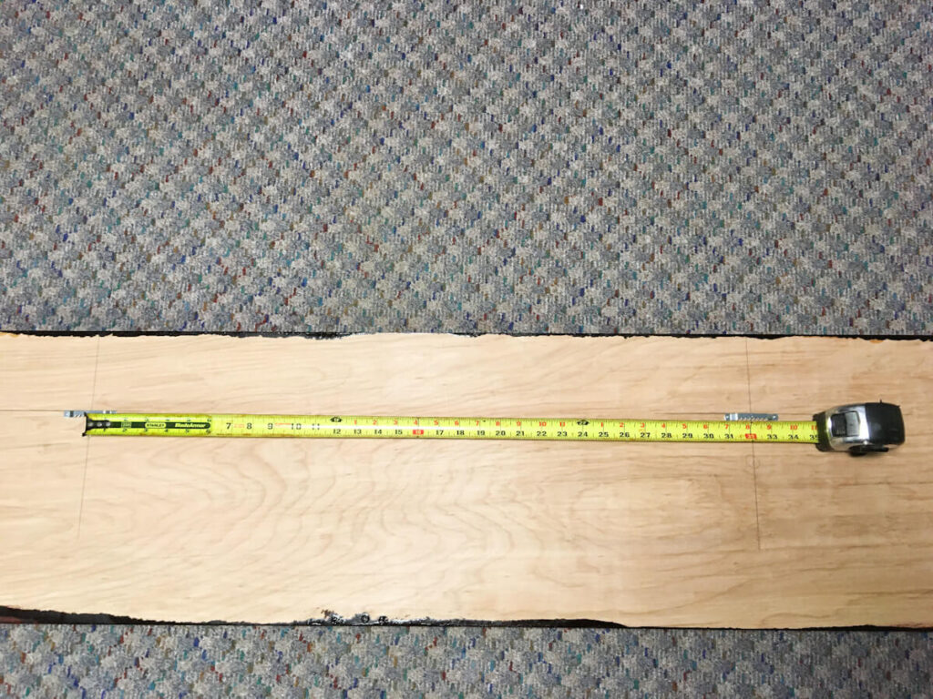 measuring tape showing how to hang large artwork