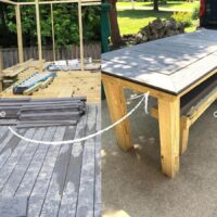 gray composite decking pile on top of deck being built with arrow pointing to gray composite decking outdoor table.