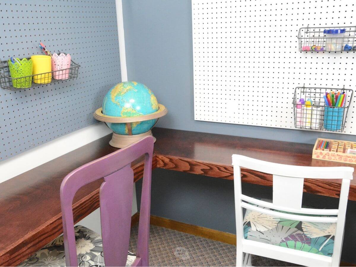 wood corner floating desk with purple and white chair with globe in the corner.