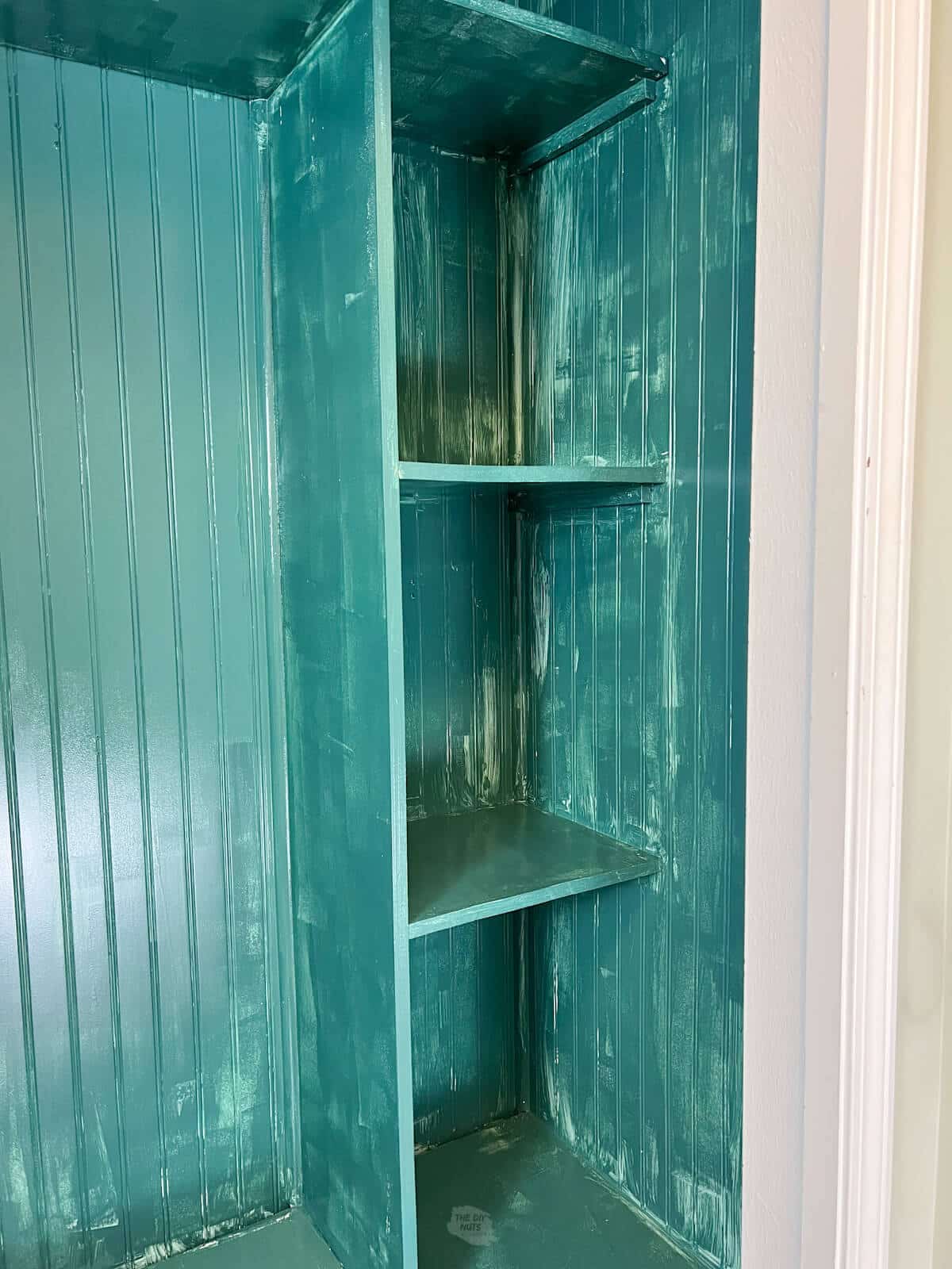 first coat of paint with blue green paint from Sherwin Willams on mudroom cubby.