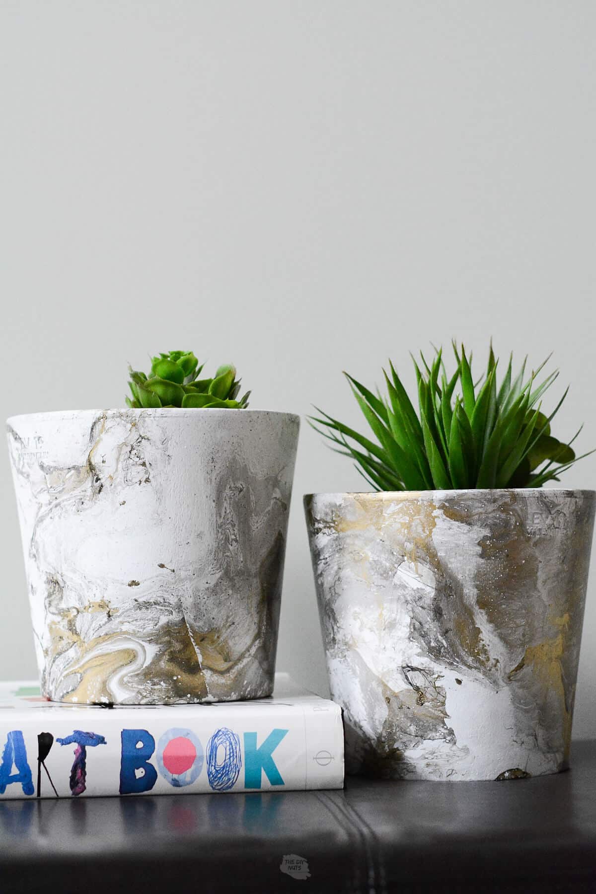 DIY marbled painted flower pots made with spray paint.