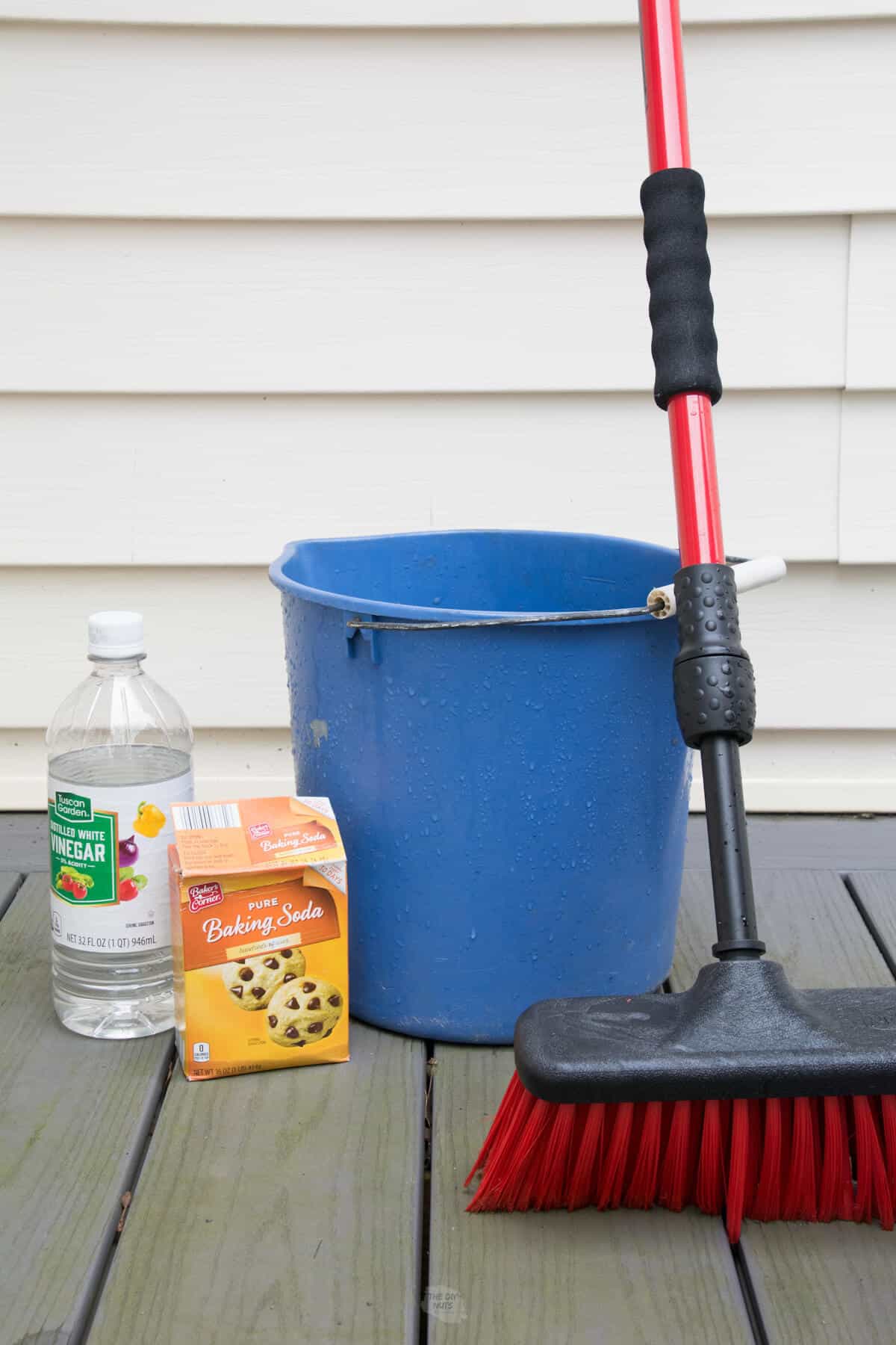 supplies used for composite deck cleaner, vinegar, baking soda, bucket and brush.