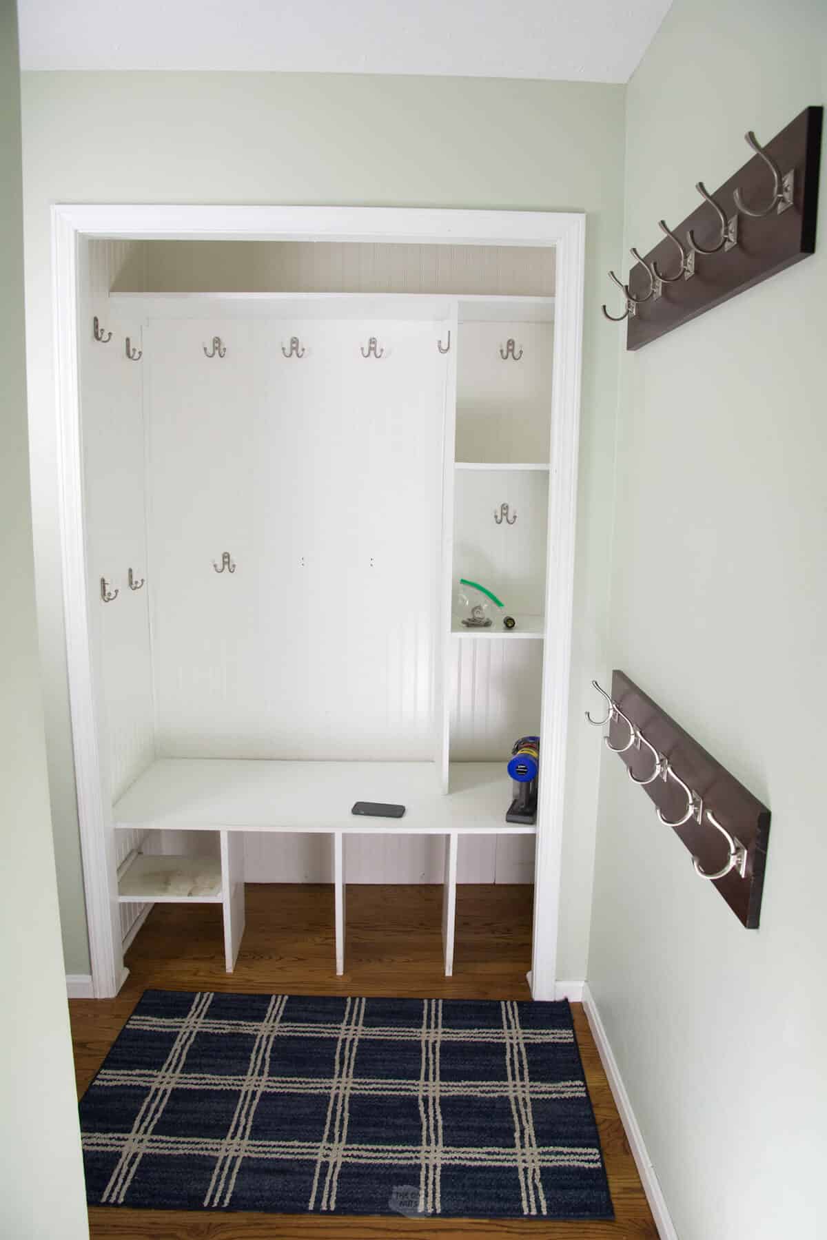 white closet cubby with hooks.