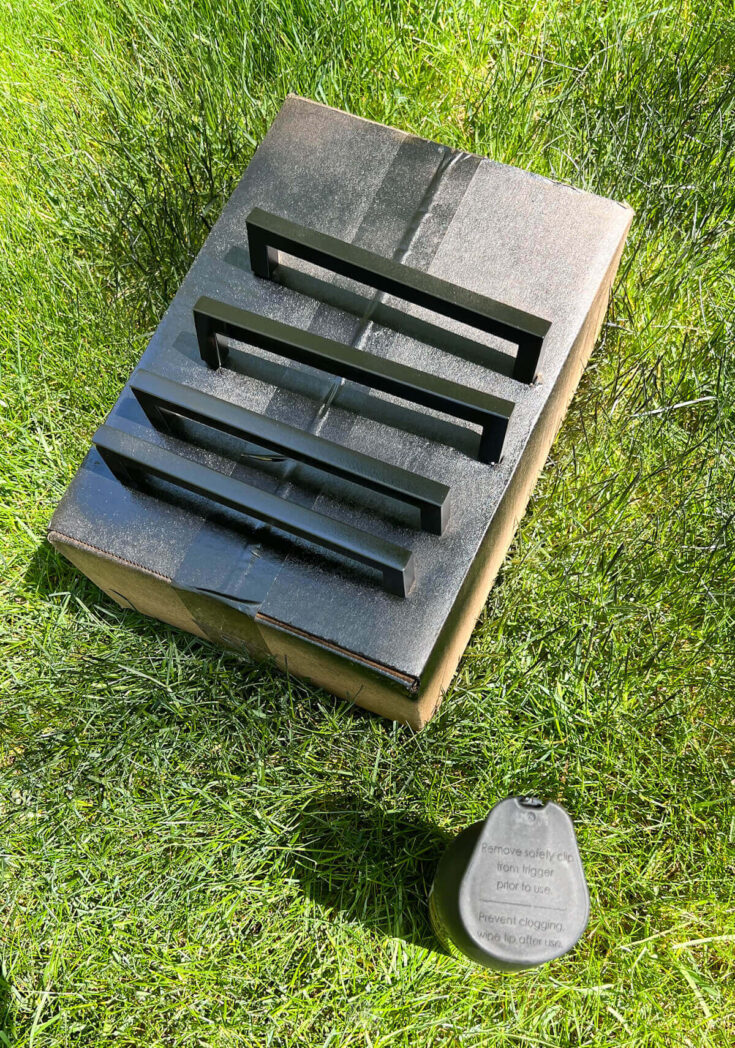 handles being sprayed with black spray paint.