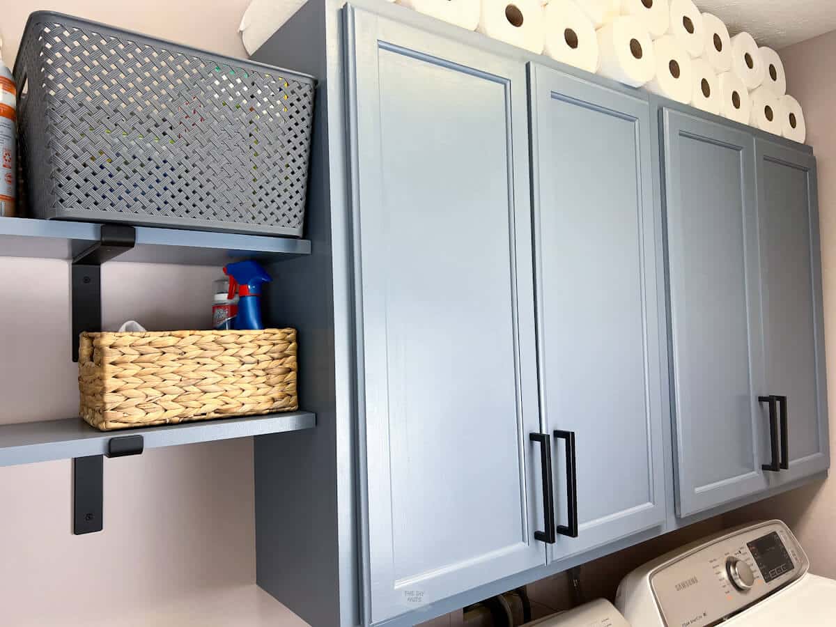 blue cabinets and shelves with black hardware.