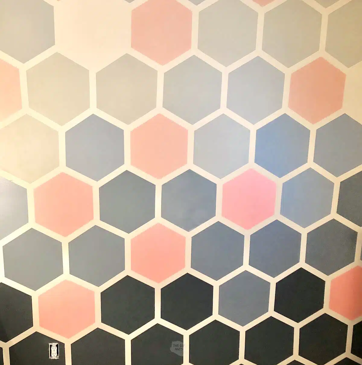 pink and gray geometric painted accent design on wall.