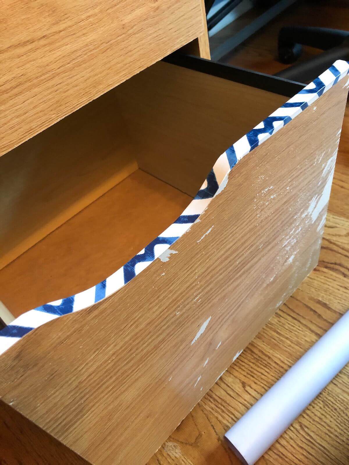 strip of contact paper on the edge of drawer of file cabinet.