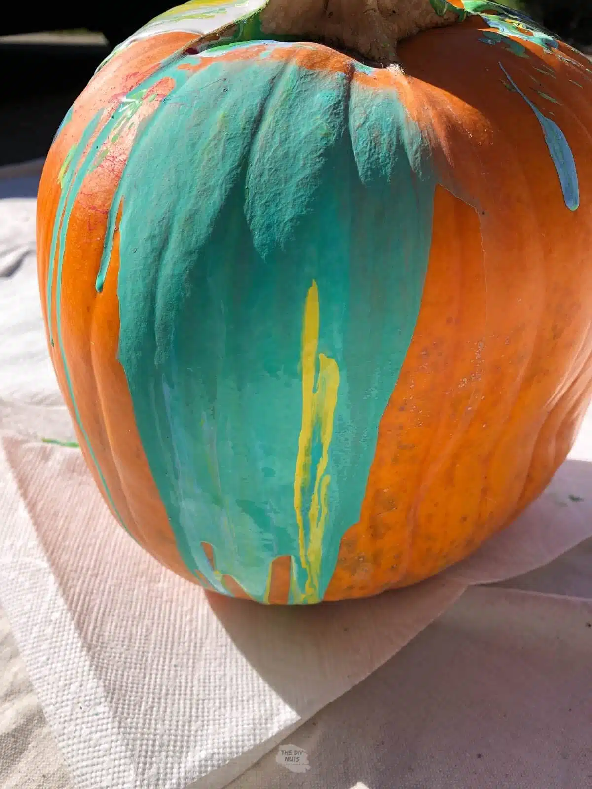 teal paint watered down too much dripping on one side of the pumpkin.
