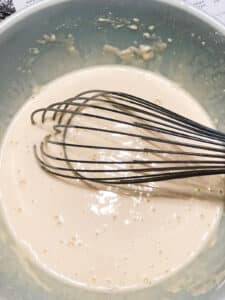whisk in bowl with paper mache paste.