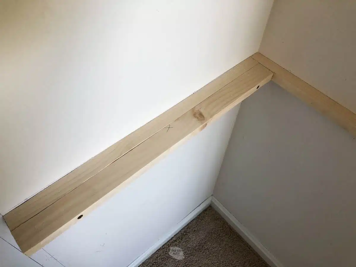 Create a DIY L-shaped shelf bracket adding extra wood for even closet shelving.