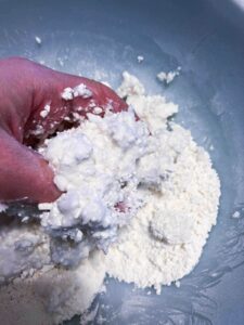 hand mixing cornstarch and lotion together.