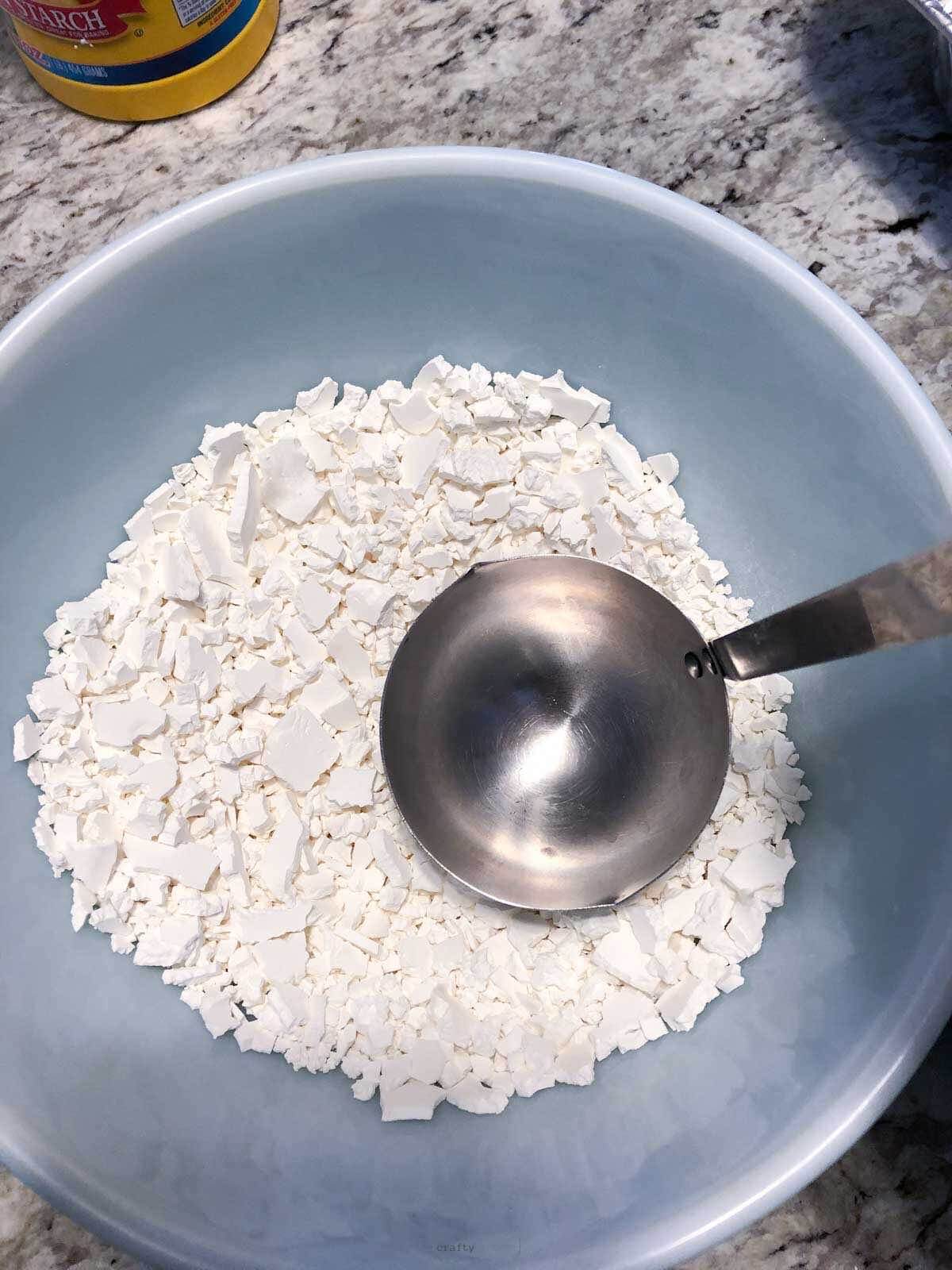 3 cups of corn starch in mixing bowl with spoon.