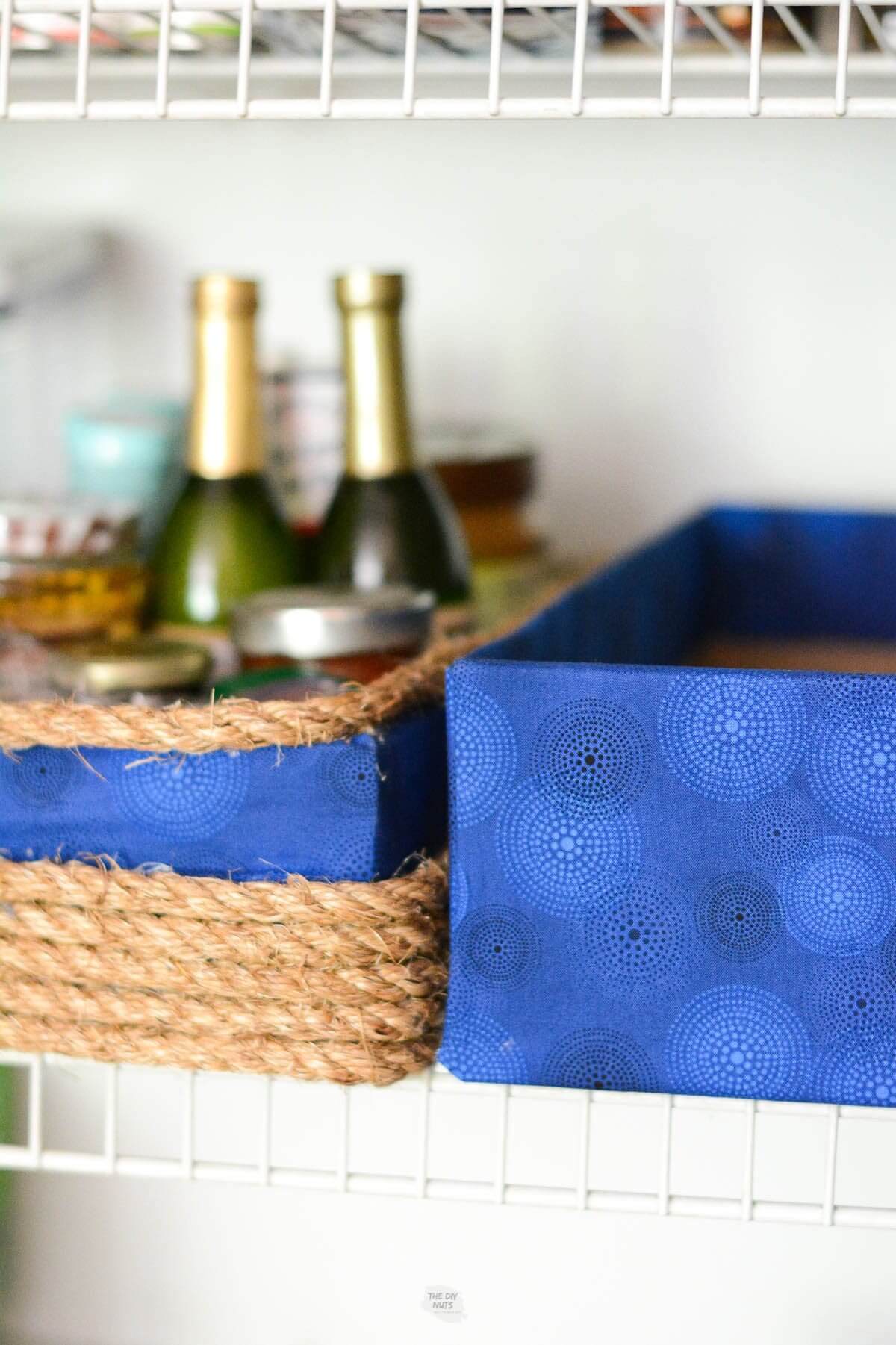blue fabric DIY storage boxes in pantry.