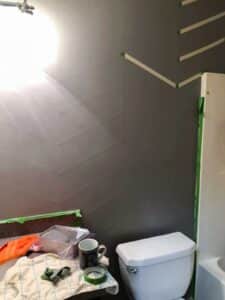 diagonal tape being pulled off the wall in bathroom.