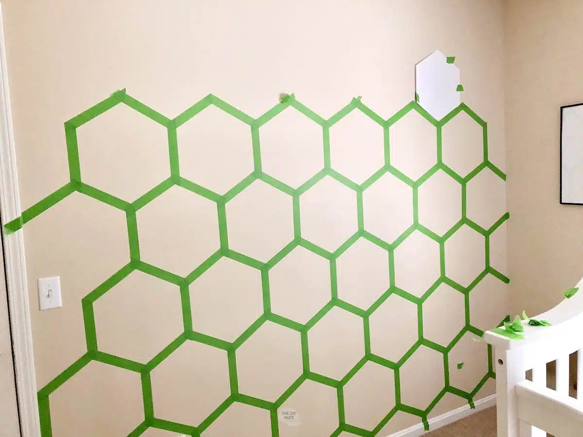 hexagon pattern taped on wall with green painter's tape.