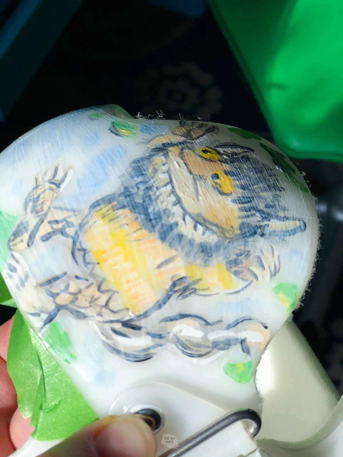 Wet mod podge on baby helmet over painted design.