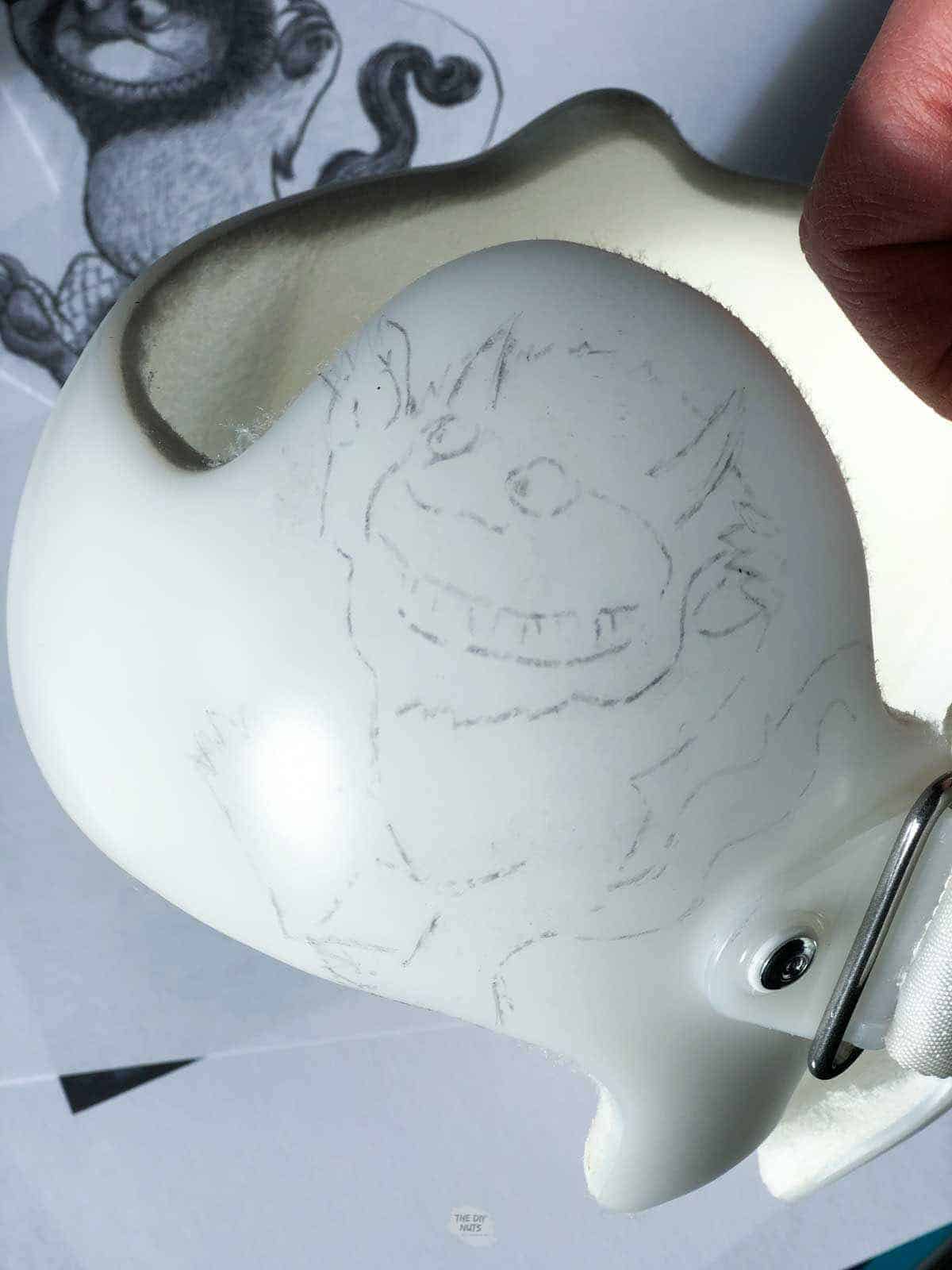 sketch of monster on baby helmet.
