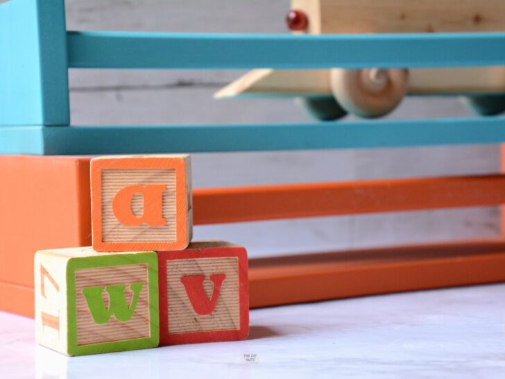 wooden blocks with colorful painted shelves behind them.