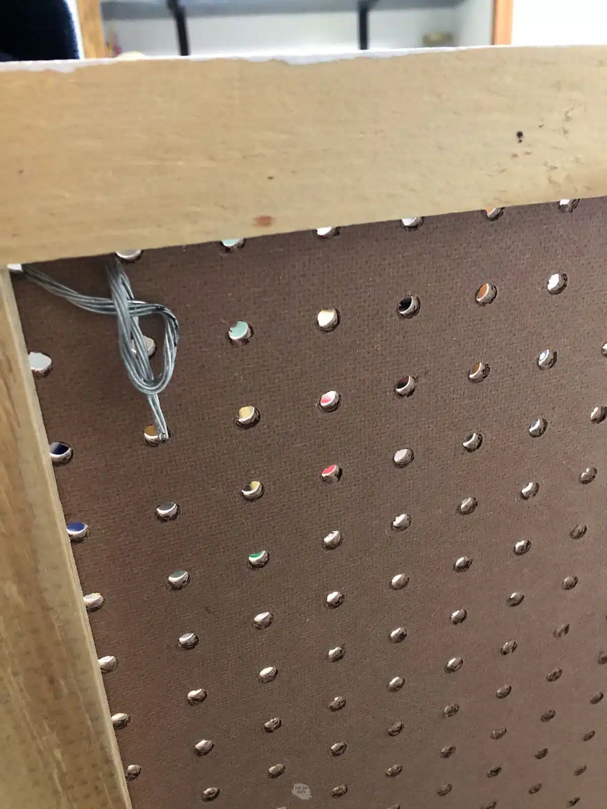 wire in pegboard hole.