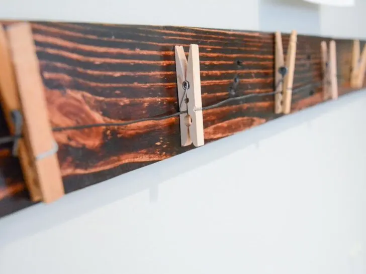 pallet wood with clothes pins on wire.
