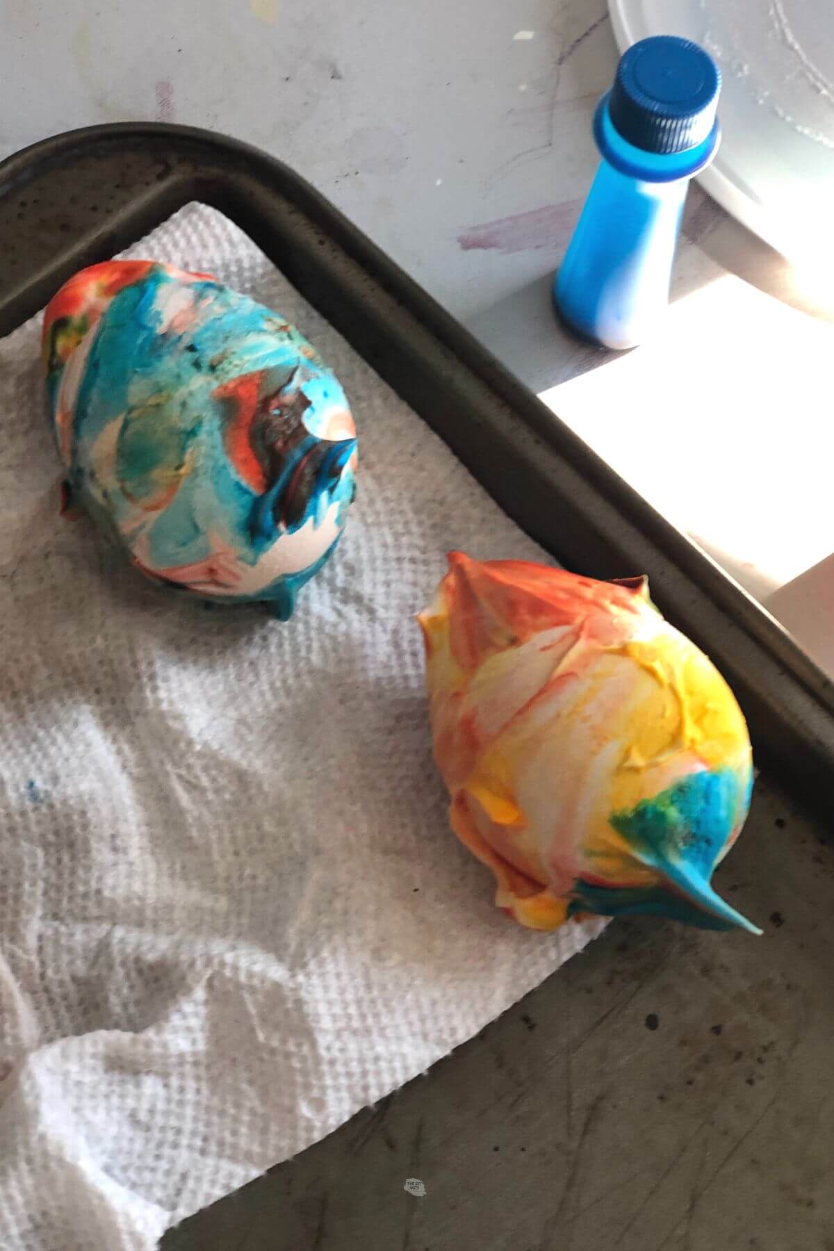 shaving cream and food coloring mixture on 2 eggs.