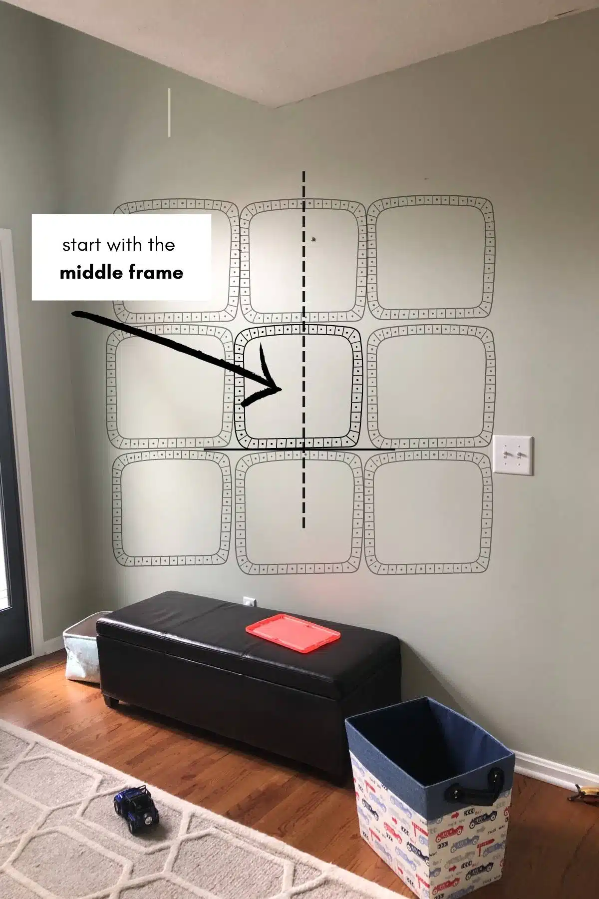 empty wall in foyer with sketched out frames with arrow pointing to middle frame.